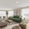 a living room with many windows, wood-style flooring and ample space for seating