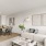 a living room and connected kitchen with wood-style flooring and ample space for seating