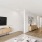 living room with ample seating and modern decor leading into a kitchen