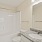 shower/tub combo in lighted bathroom