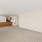 carpeted living room adjacent to large kitchen