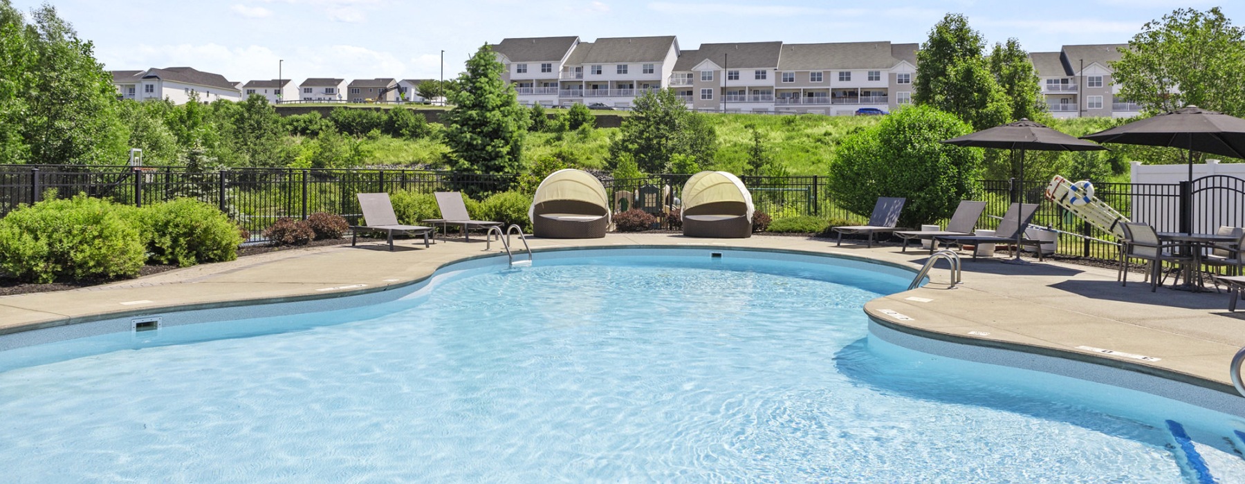 Resort-style swimming pool with lounge seating